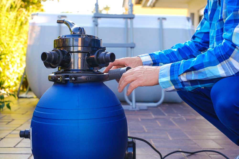 A man working on pool filter