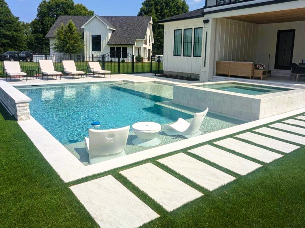 geometric pool with attached spa and tanning ledge