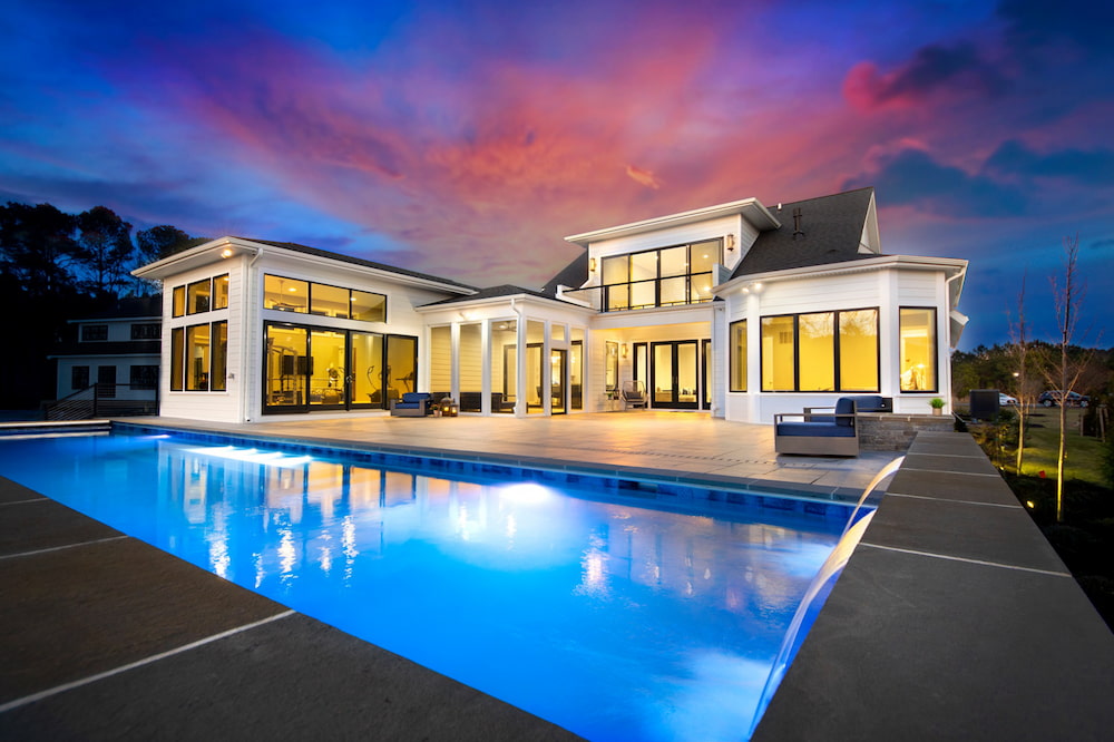 beautiful geometric custom pool with water features at sunset