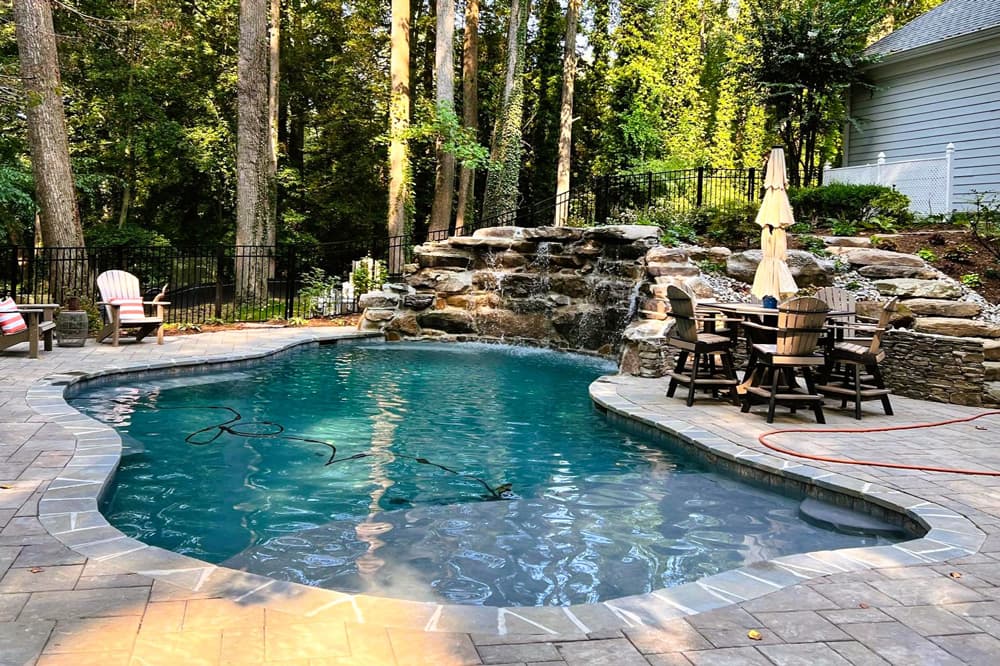 freeform pool with beautiful waterfall over boulders