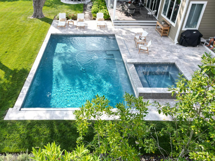 geometric pool with spillover spa